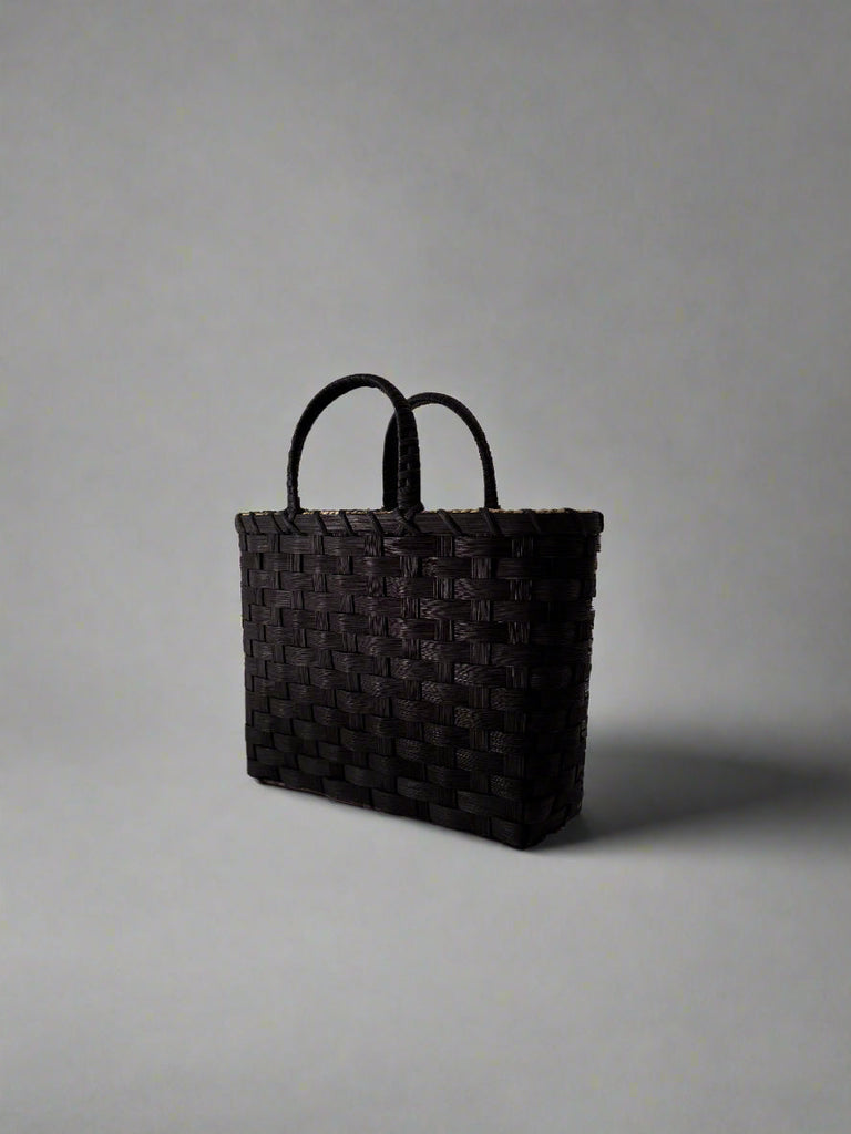 Black woven bag on a white background