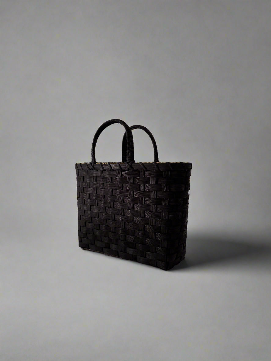 Black woven bag on a white background
