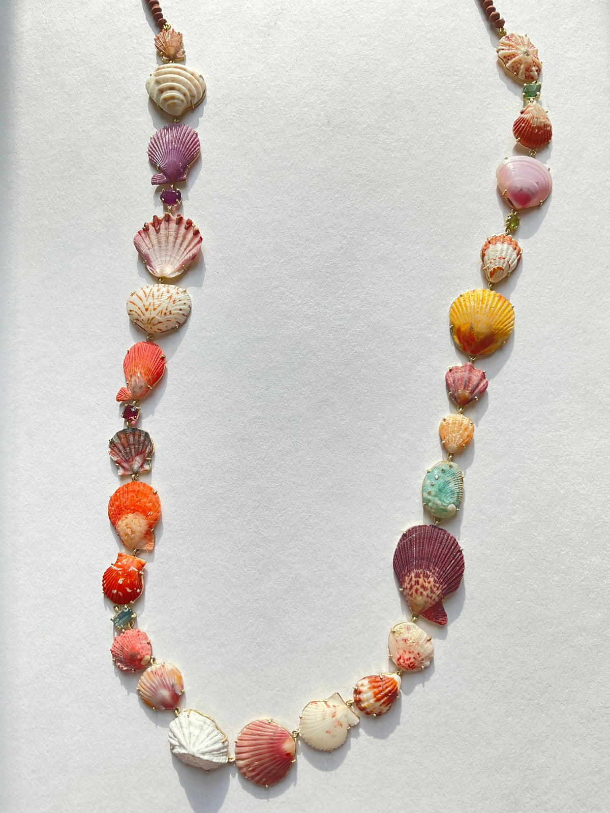 Full view of Multi Long Shell Necklace with Gems and Diamonds showcasing multicoloured shells and brown jade beads on white