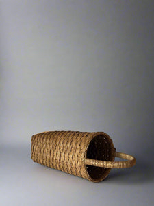 Woven basket with handles on a plain background