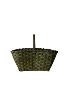 Woven basket with a handle on a plain background