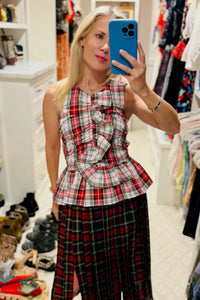 The Doering Top is a fitted V-neck silhouette with ruffles, shirring, and a peplum waist. 