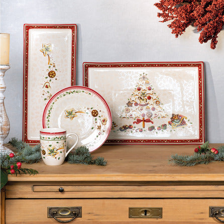 Front view of Winter Bakery Delight mug showcasing Falling Star motif and red rim on wooden tabletop with matching plates
