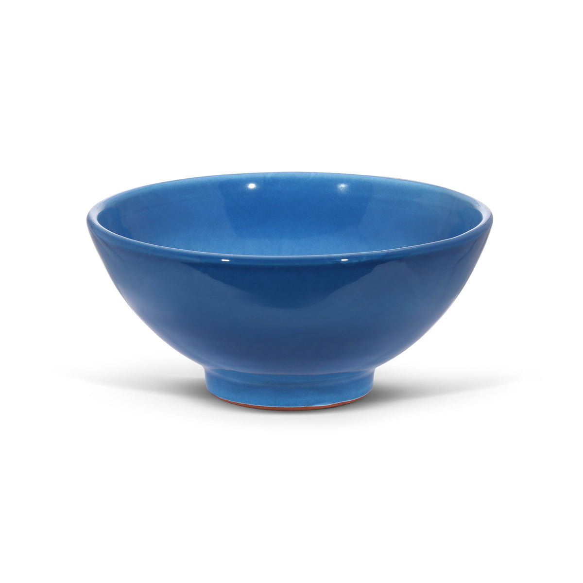 Three-quarter view of medium terracotta bowl showcasing glossy cobalt blue glaze on white background