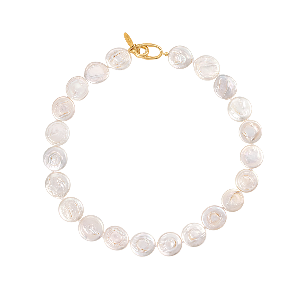 Top down view of the Soulmate Necklace showcasing flat lustrous coin pearls and a gold toggle clasp on a white background