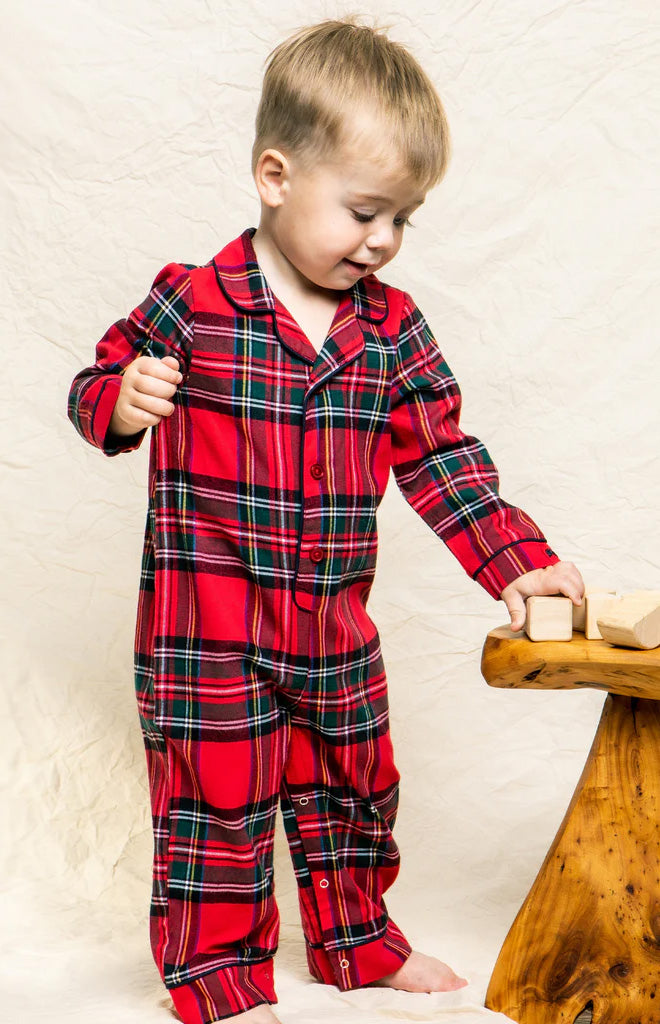 Front view of Imperial Tartan romper showcasing red tartan plaid, spread collar, long sleeves, and snap leg closures on a toddler against a cream backdrop