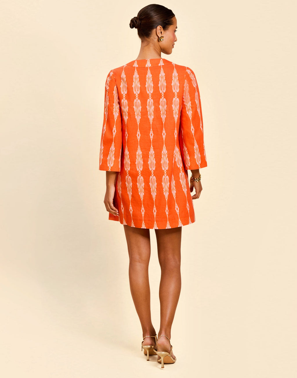 Ines Caftan Mini Dress in Hibiscus Mosaic linen with embroidered palm details, djellaba collar, and relaxed caftan silhouette.