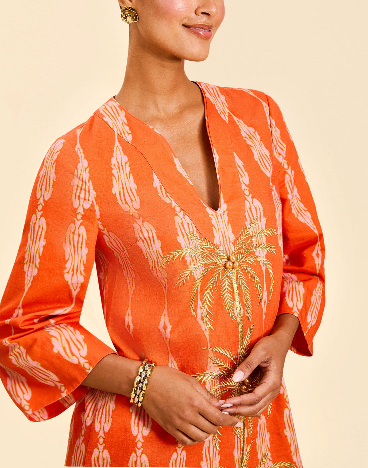 Ines Caftan Mini Dress in Hibiscus Mosaic linen with embroidered palm details, djellaba collar, and relaxed caftan silhouette.