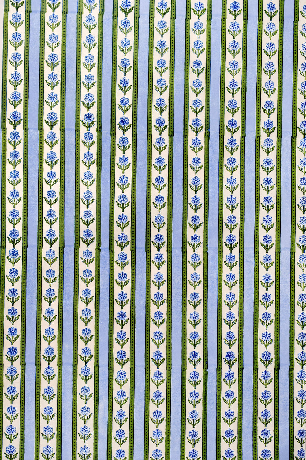 Close-up of Blockprint Cottage Garden gift wrapping paper sheets in blue showcasing vertical floral stripes