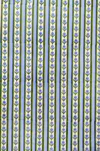 Close-up of Blockprint Cottage Garden gift wrapping paper sheets in blue showcasing vertical floral stripes