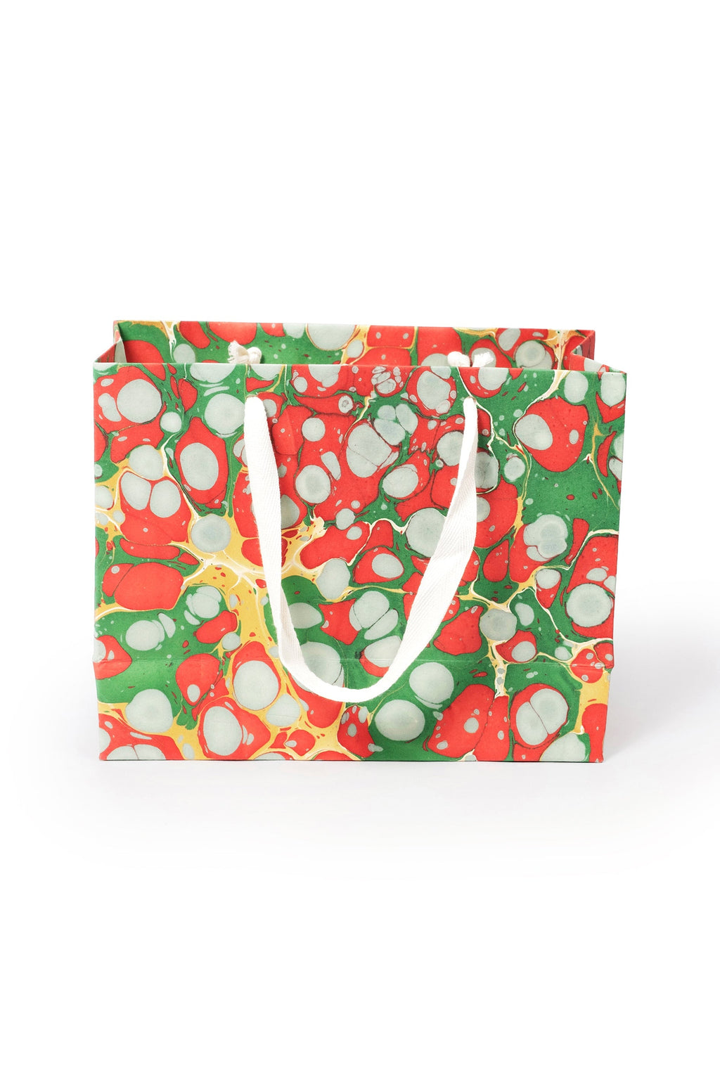 Medium Christmas Gems hand-marbled gift bag in red, green, white, and gold with white handles, front view.