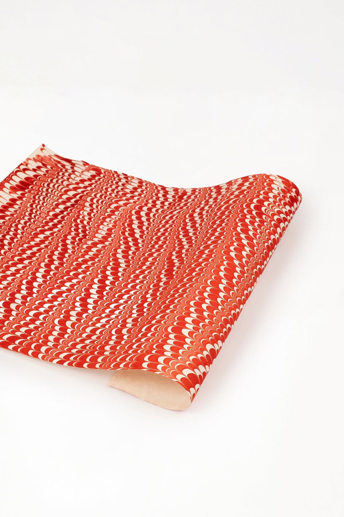 Red and white hand marbled candy cane swirl gift wrapping paper sheet