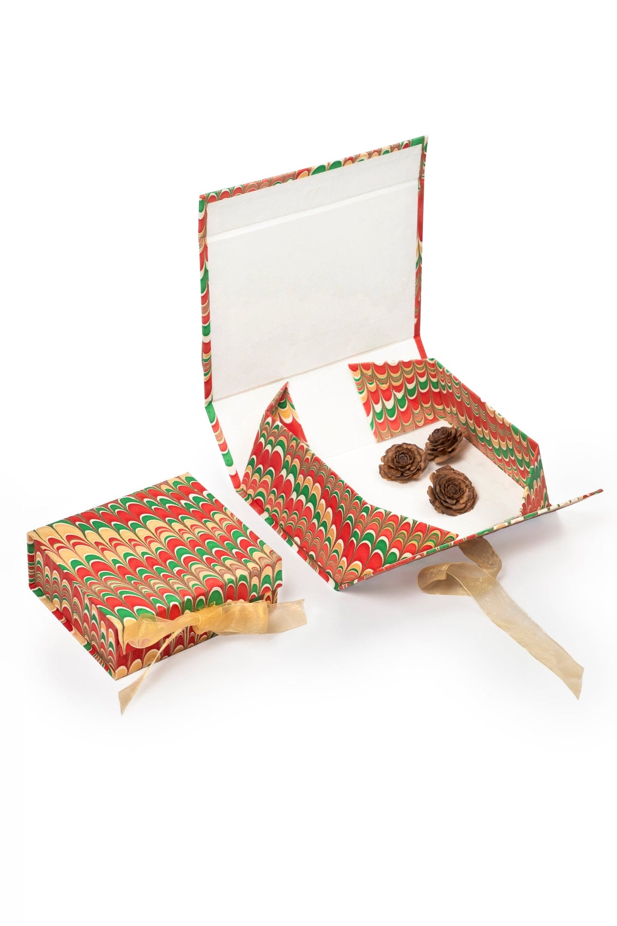 Inner Child hand-marbled collapsible marbled holiday keepsake box open with pine cone decor
