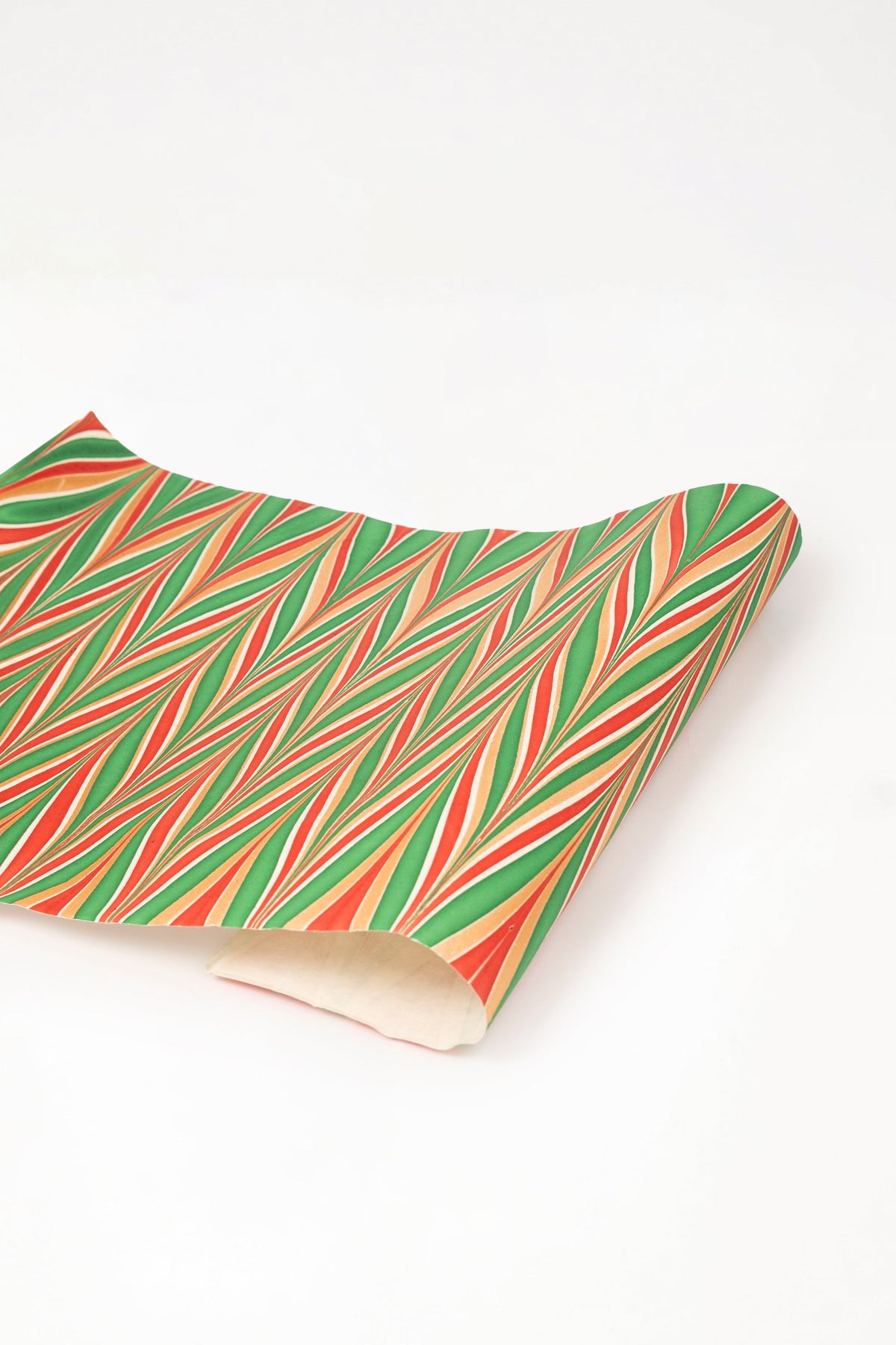 Hand marbled gilded holiday gift wrapping paper single sheet with red green gold striped pattern