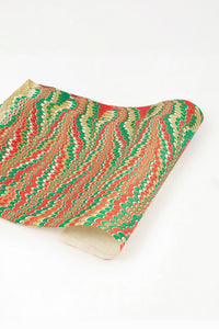 Hand marbled holiday jingle gift wrapping paper single sheet with red green gold peacock pattern