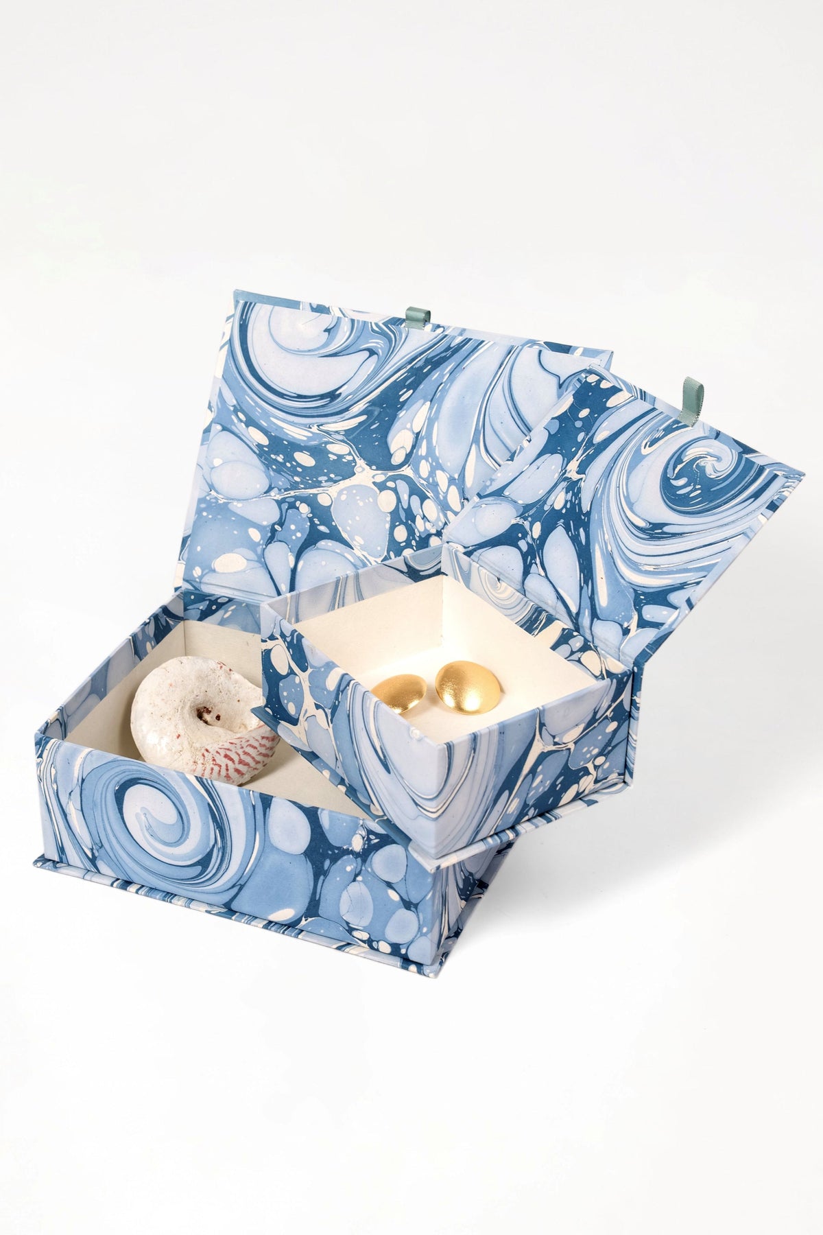 Open blue ocean wave keepsake box with decorative items