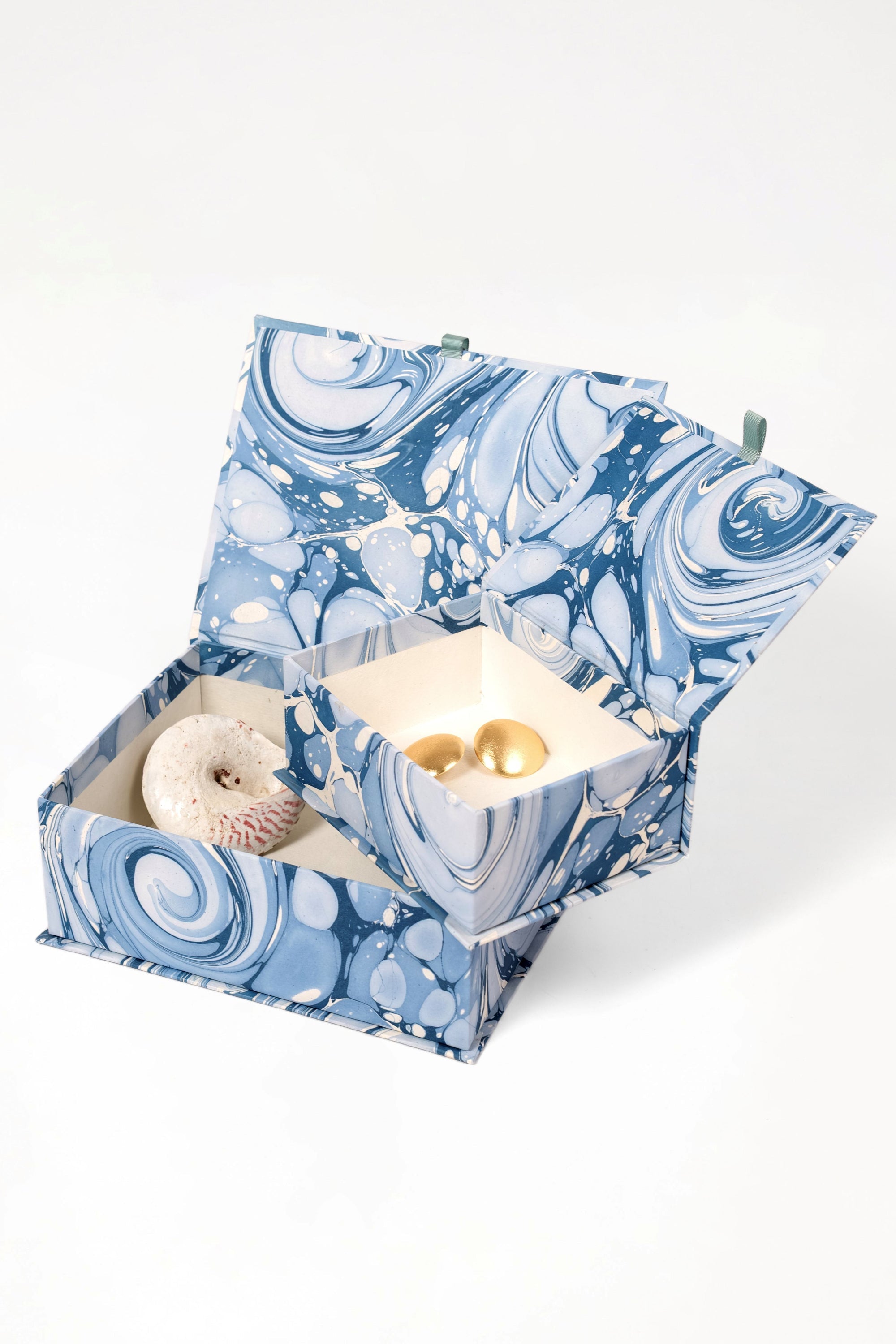 Open blue ocean wave keepsake box with decorative items