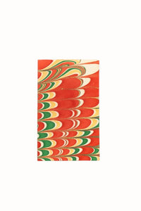 Close-up of hand-marbled notecard with red green yellow swirling patterns - Inner Child