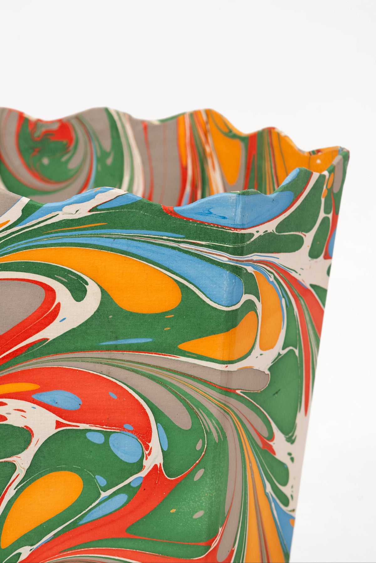 Inner Child hand-marbled scallop waste bin with colorful marbled patterns