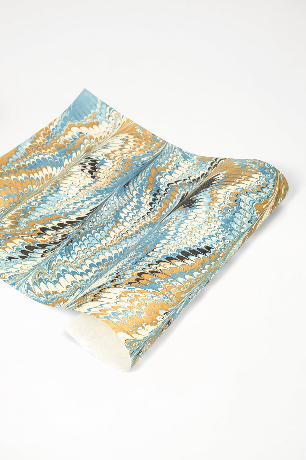 Rolled hand-marbled blue-gold-black paper from Inner Child