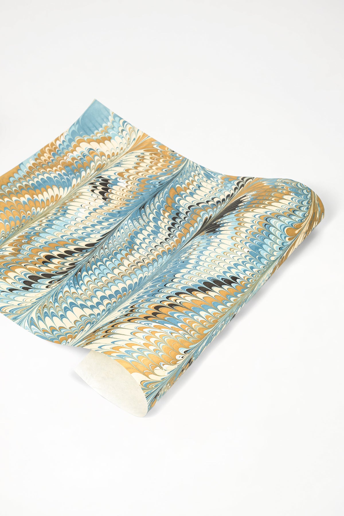 Rolled hand-marbled blue-gold-black paper from Inner Child
