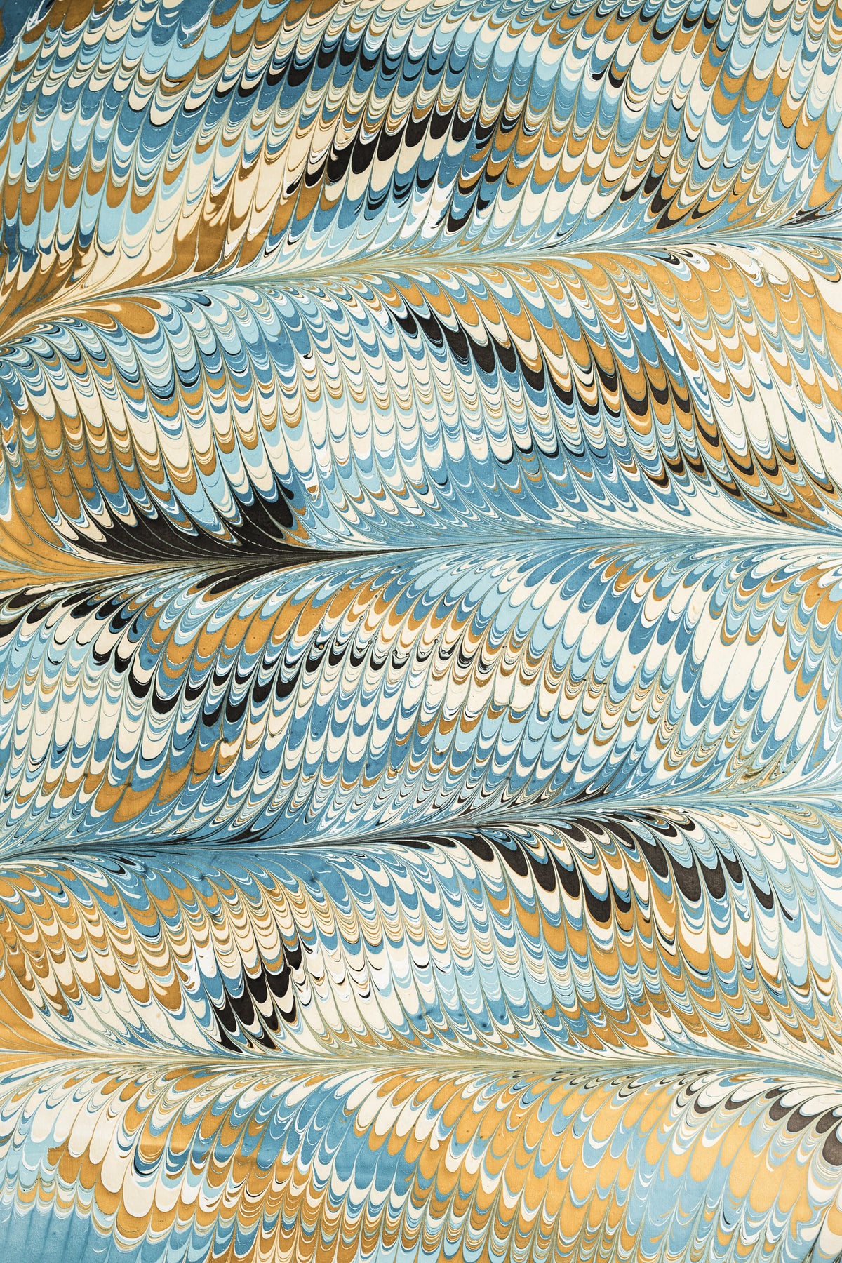 Detailed hand-marbled blue-gold-black pattern from Inner Child