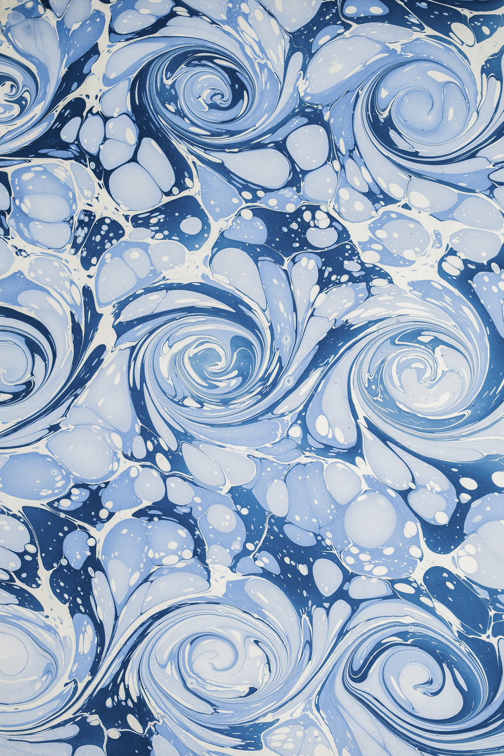 Detailed hand-marbled blue ocean wave pattern with swirls and bubbles