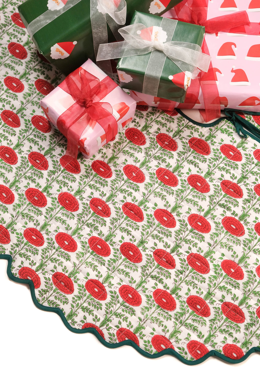 Scallop-edged quilted tree skirt with red blockprint floral patterns