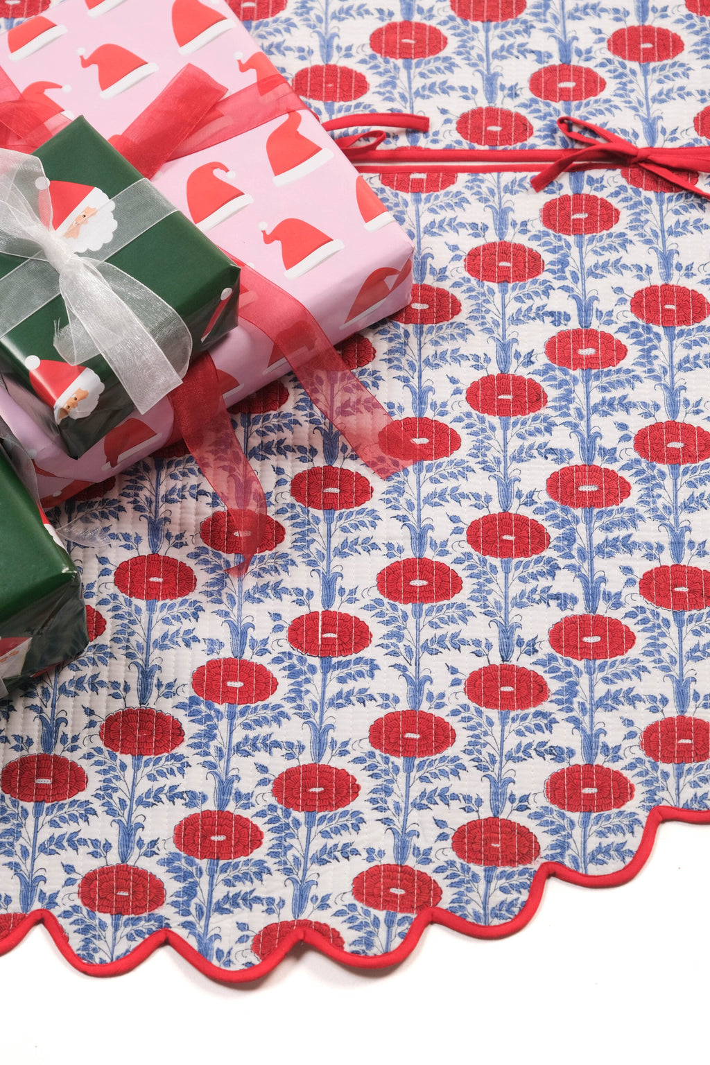 Scallop blockprint quilted tree skirt with red flowers, blue leaves, Araminta Red + gift boxes