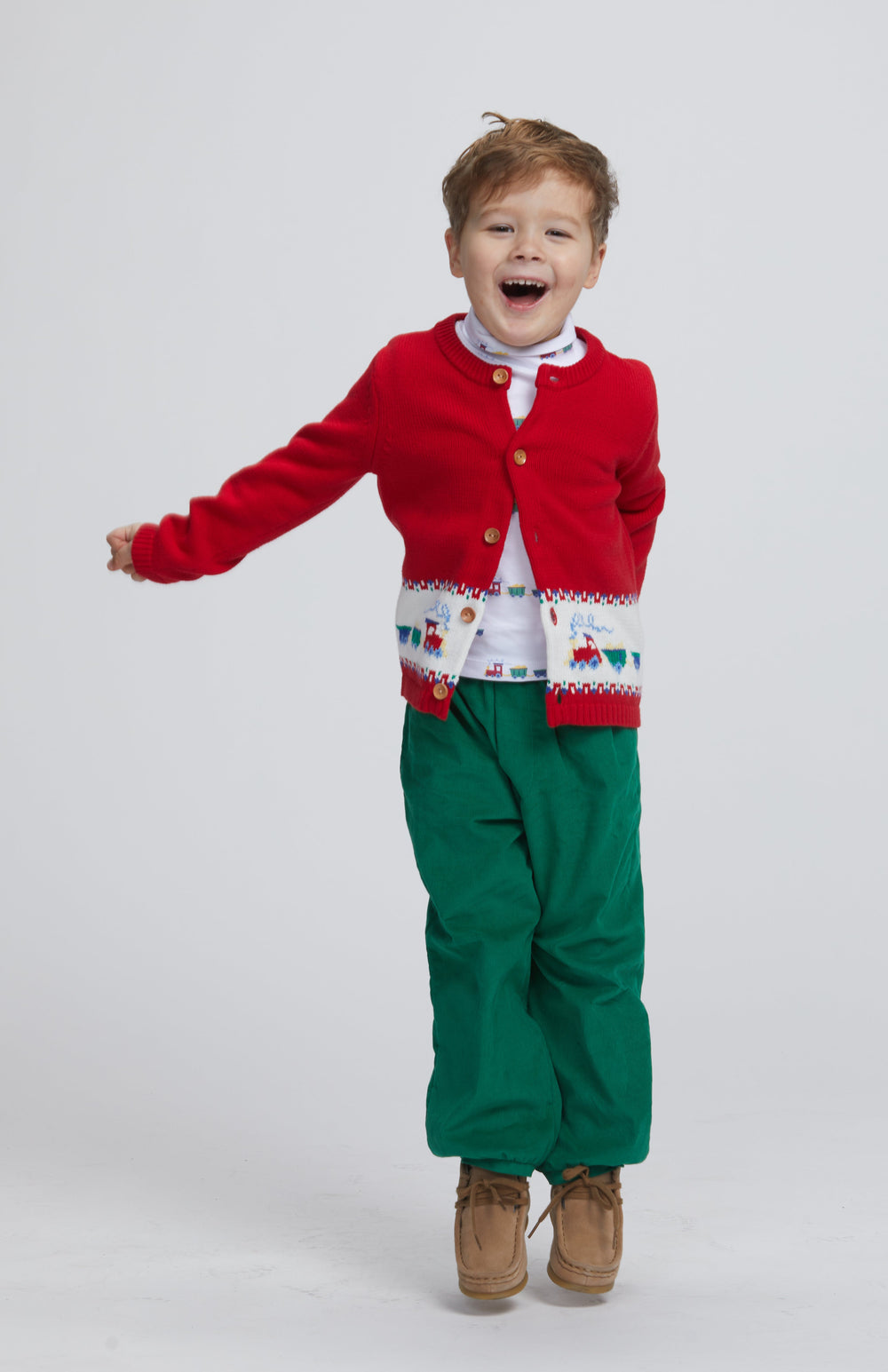 Front view of banded pant in evergreen corduroy worn by child model showcasing elastic pull-on waistband with light gray studio background