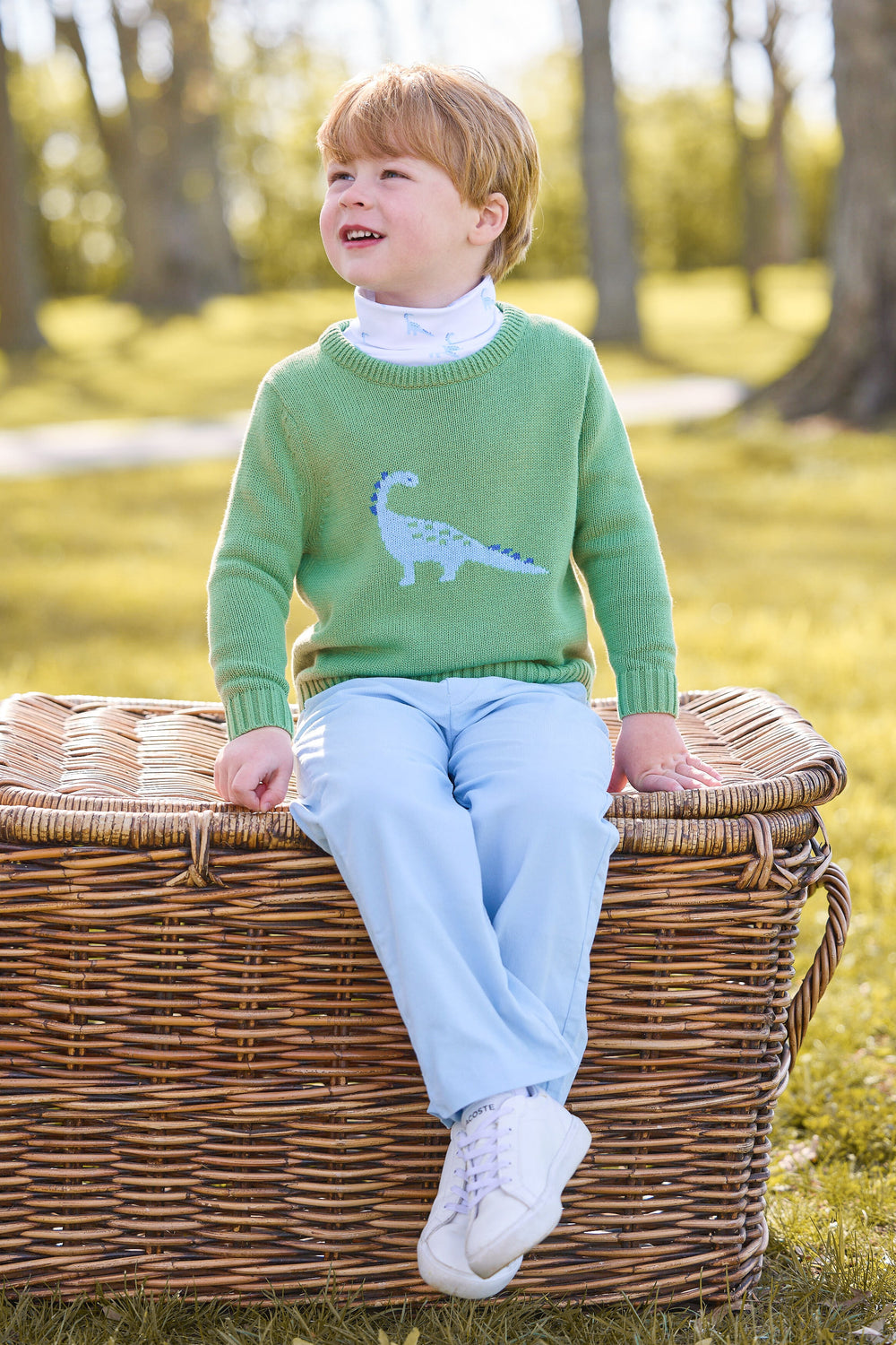 Front view of green Intarsia Sweater featuring a blue dinosaur on a child model, paired with light blue corduroy pants