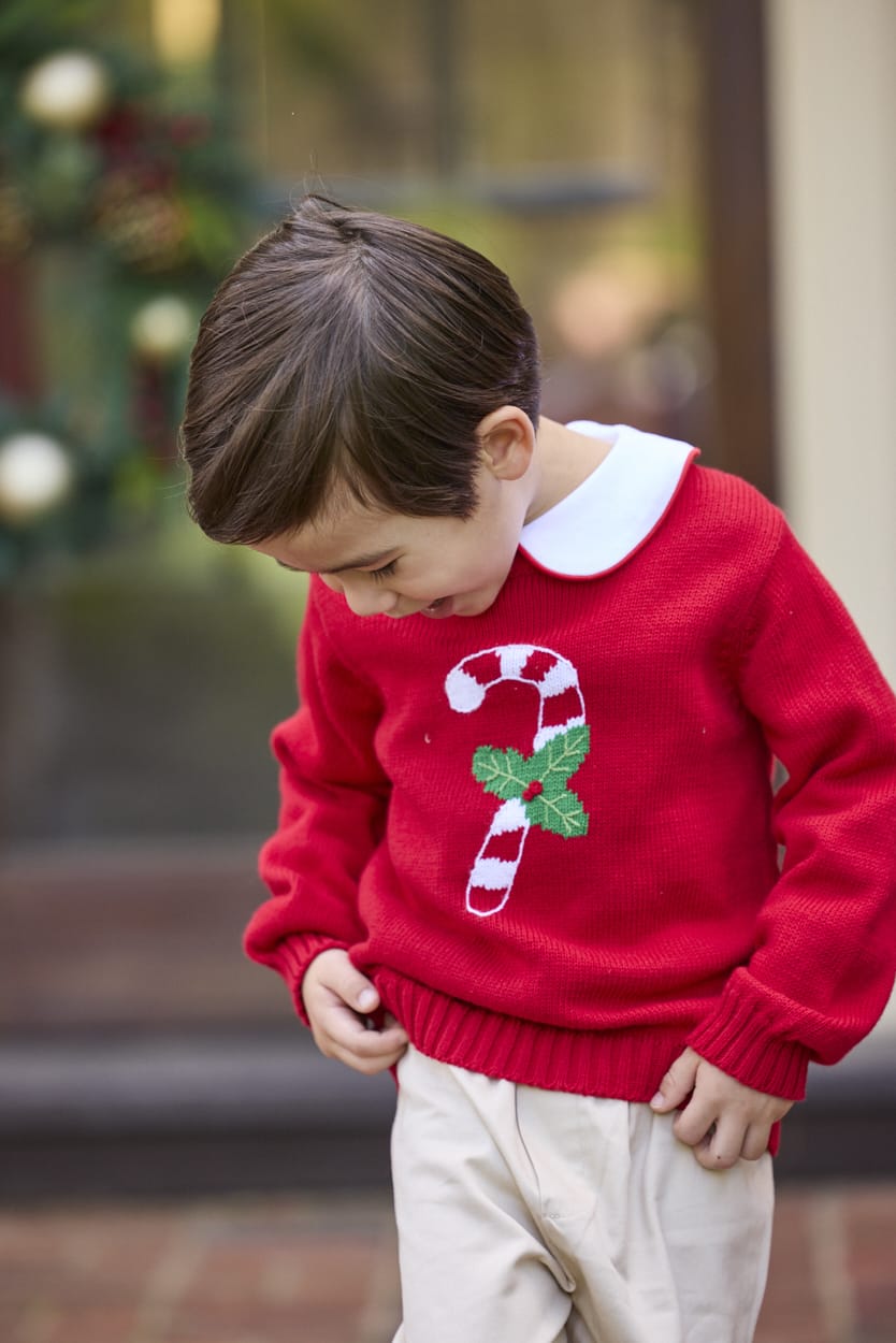 Little English traditional children's clothing. Red Intarsia Sweater with candy cane motif for boys and girls layered over red piped white knit peter pan shirt and khaki pebble twill banded pants.