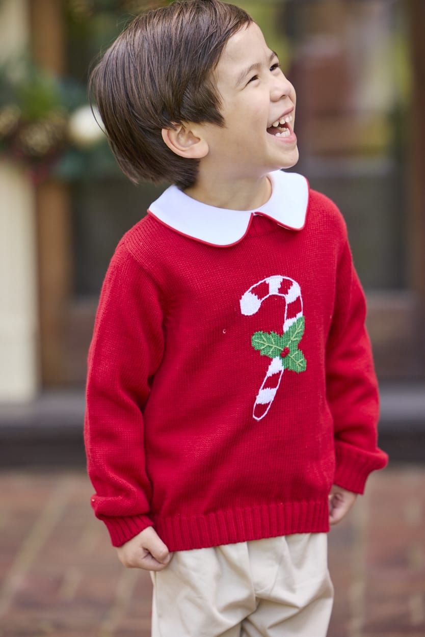 Little English traditional children's clothing. Red Intarsia Sweater with candy cane motif for boys and girls layered over red piped white knit peter pan shirt and khaki pebble twill banded pants.