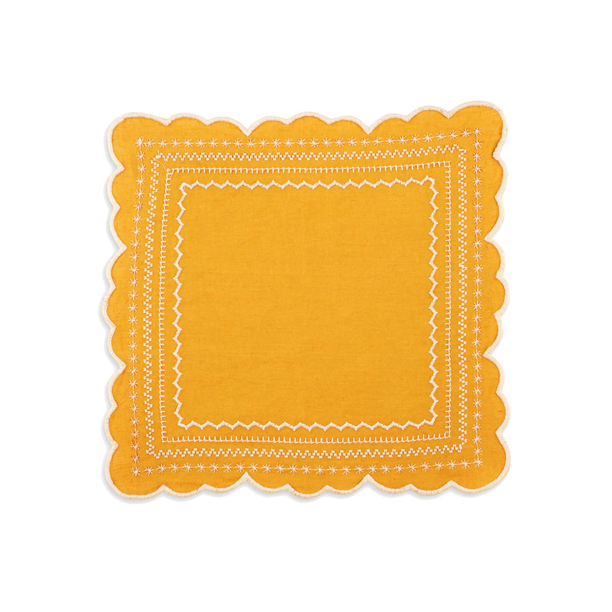 Top-down view of Isabelle napkin in mustard showcasing scalloped edges and white embroidered border on white background