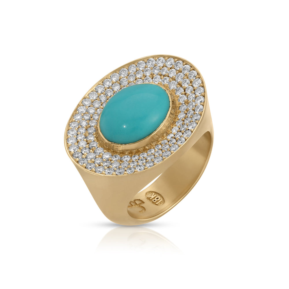Three-quarter view of Eyecon ring with oval turquoise center and pavé diamond halo on 18k yellow gold band, white background