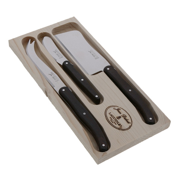 Angled view of cheese set in wenge wood with cleaver, knife, and spreader in a light wood tray