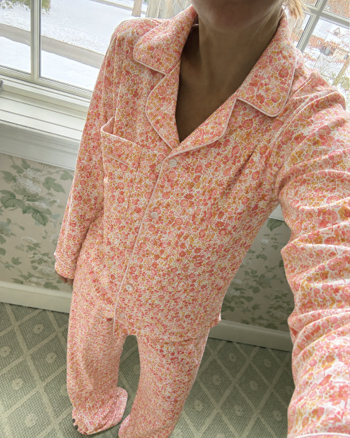 Front view of Marigolds women’s long pajama set showcasing pink floral print on a model indoors