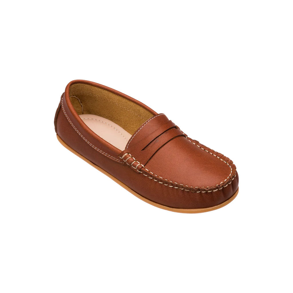 Three-quarter view of JP Moccasin Toddlers Saddle showcasing premium suede-like leather and a penny-style strap on a white background
