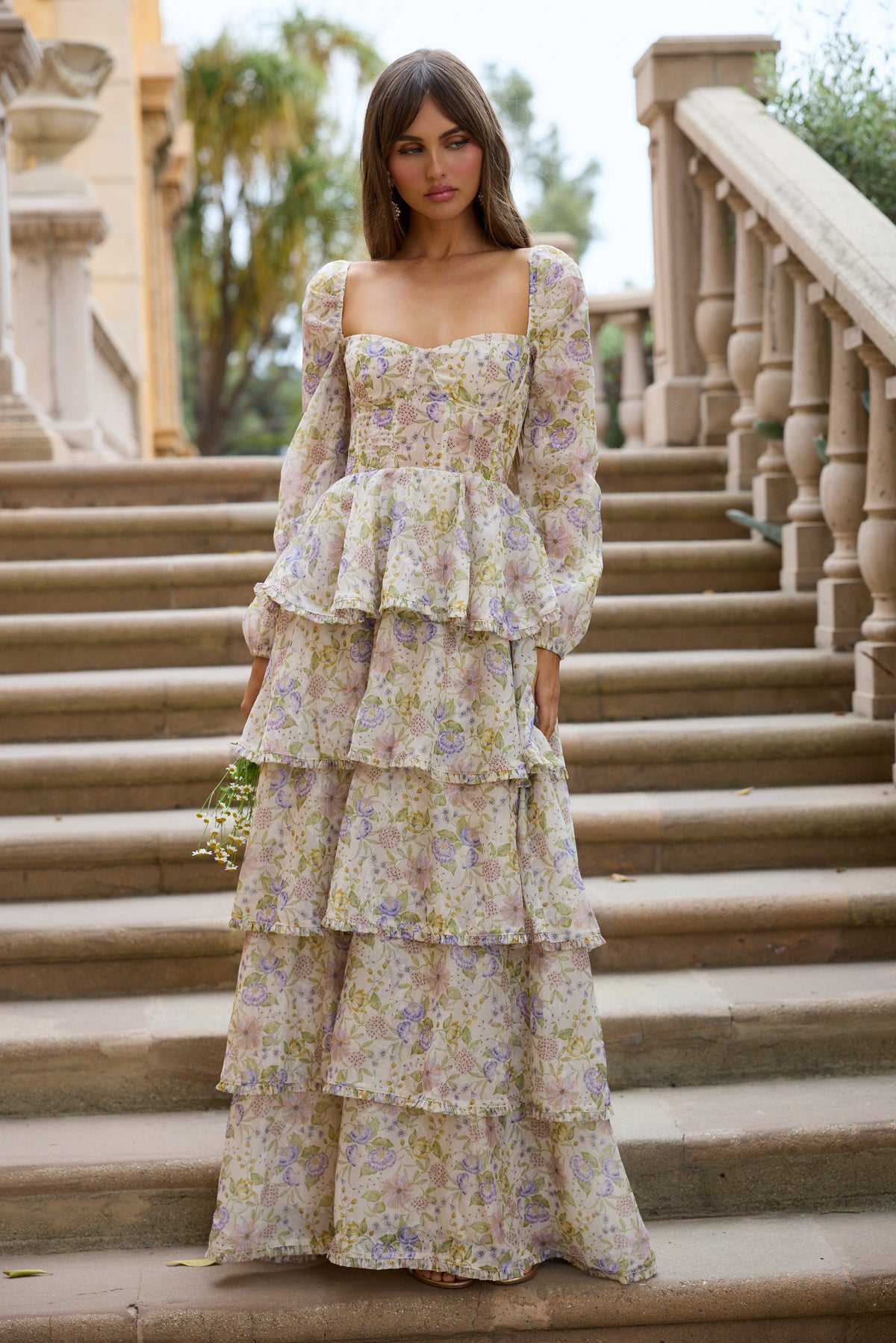 Front view of The Juliette Dress in Cordoba Print showcasing cream floral organza, gathered tiers, and long sleeves on steps