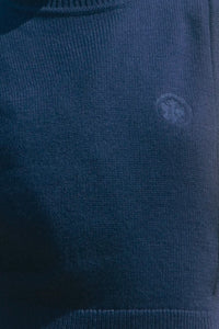 Navy wool blend turtleneck with an open side seam with embroidered eyelet ties.