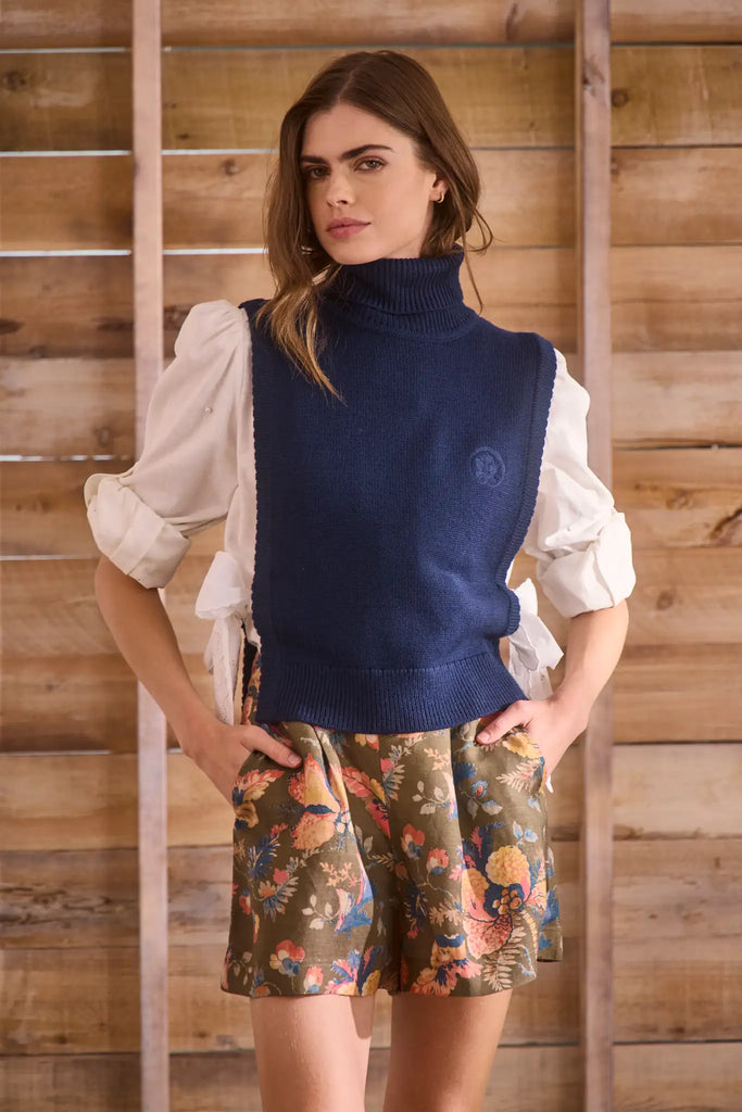 Navy wool blend turtleneck with an open side seam with embroidered eyelet ties.