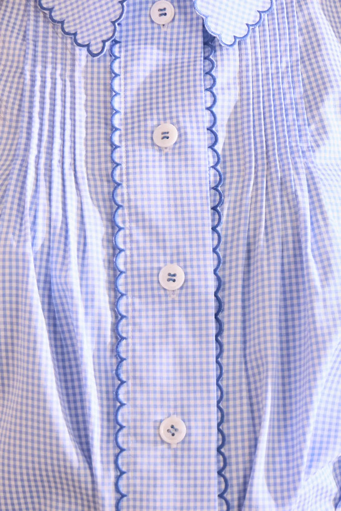 Blue and white gingham button down with a button front placket, shoulder puffing, and pintuck detail