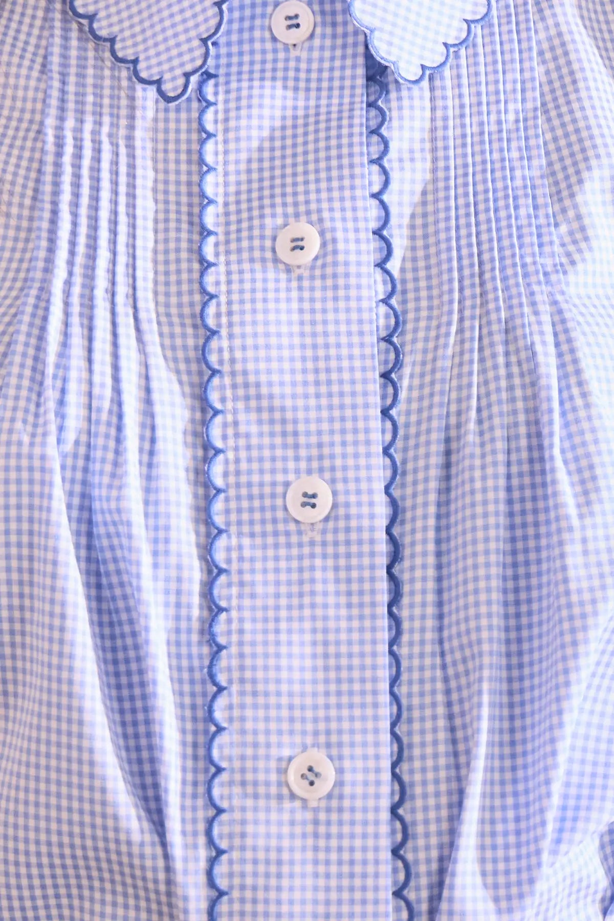 Blue and white gingham button down with a button front placket, shoulder puffing, and pintuck detail