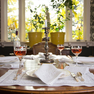 A beauty shot of a tablescape with white on white placemats and napkins