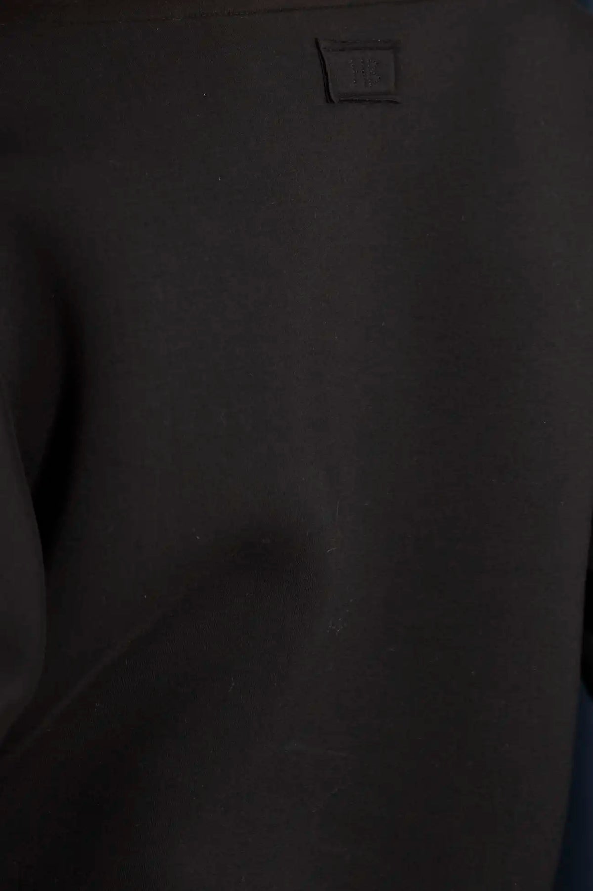 The Jennie Sweatshirt is a structured scuba in deep Onyx with pleated long sleeves.