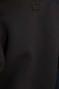 The Jennie Sweatshirt is a structured scuba in deep Onyx with pleated long sleeves.