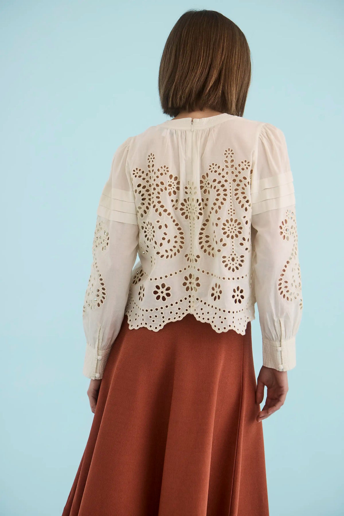 The Jennifer Top in Ivory paired with the Joan Skirt in Rust. 