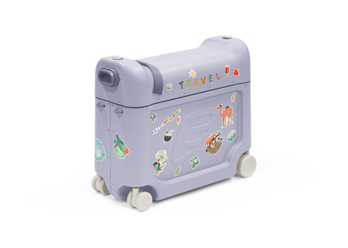 Angled front view of JetKids BedBox suitcase in arctic blue with 4 spinner wheels, handle, stickers on white