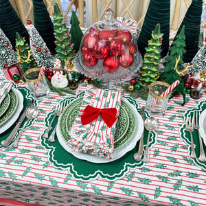 red stripe christmas tablecloth with christmas trees. Hand block printed. Red and green. with matching napkin and luxury placemat and velvet napkin bow. 