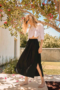 The Tatum black midi skirt was made for ease and style with a covered elastic waist and relaxed fit.